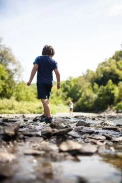 Children playing in a river Foto stock