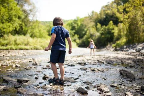 Children playing in a river Stock Photos