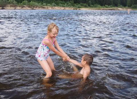 Children playing in the river Stock Photos