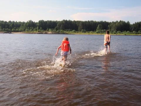 Children playing in the river Stock Photos