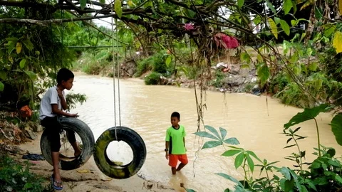 Children playing at the riverbank. Stock Footage 88619957