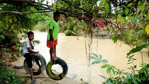 Children playing at the riverbank. Stock Footage 88620043
