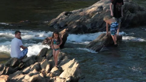 Children playing on rocks in river Stock Footage 40220290