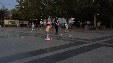 Children playing roller skating on sunset time lapse Stock Footage 82117627