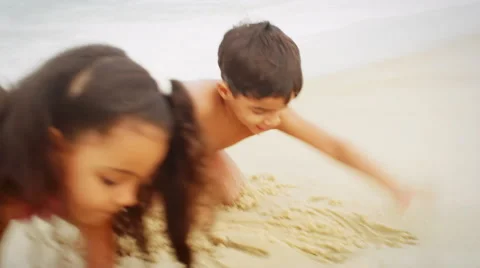 Children playing in sand on a beach Stock Footage 49580517