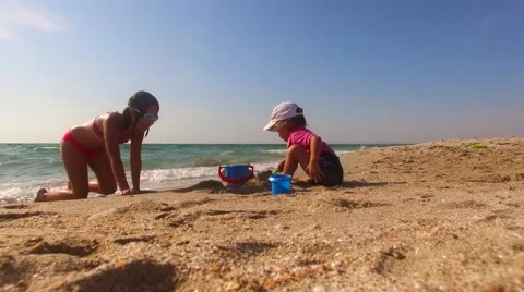 Children Playing With Sand On The Beach Stock Footage 57173393