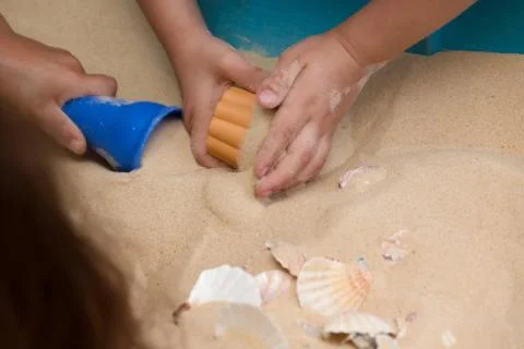 Children Playing In The Sand Stock Photos