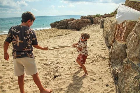 Children Playing on a Sandy Beach Stock Photos