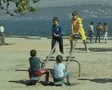 Children playing on see-saw by river SD Footage