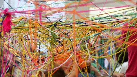 Children Playing with Skeins of Multicolored Wool Stock Footage 80541870