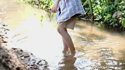 Children playing in the small canals. Stock Footage 166954465