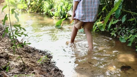 Children playing in the small canals. Stock Footage 166954542