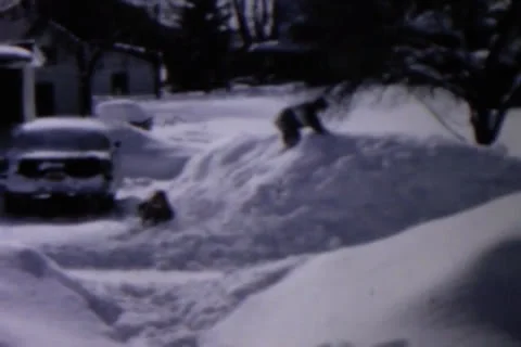 Children Playing in Snow Mound Stock Footage 24672299