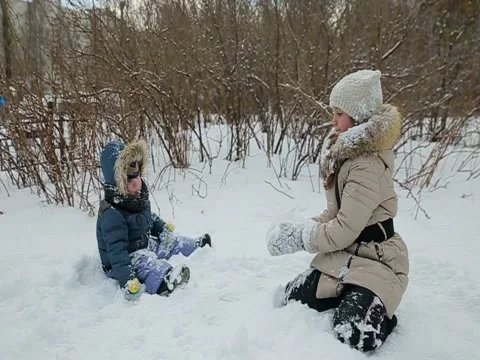 Children playing in the snow slow motion Stock Footage 73356112