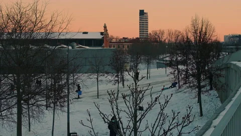 Children playing in the snow at sunset Stock Footage 151474727