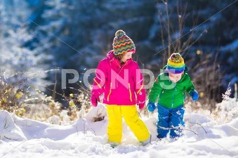 Children playing in snowy winter park Stock Photos