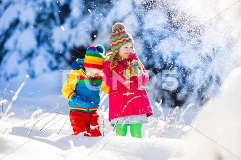Children playing in snowy winter park Stock Photos
