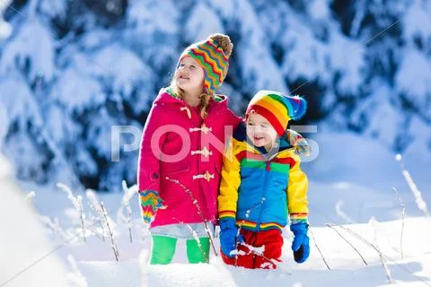 Children playing in snowy winter park Stock Photos