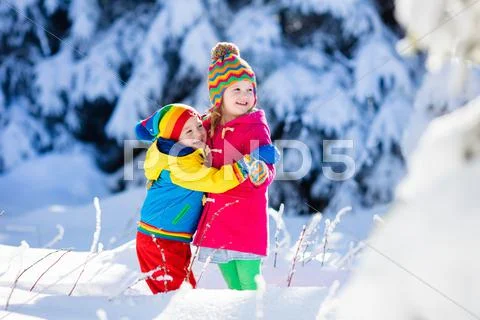 Children playing in snowy winter park Stock Photos