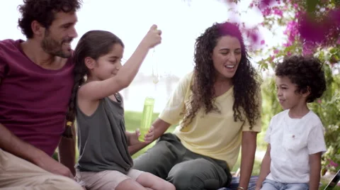 Children playing with soap bubbles at park. Stock Footage 63510453