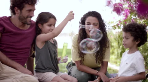 Children playing with soap bubbles at park. Stock Footage 63510499