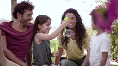 Children playing with soap bubbles at park. Stock Footage 63510560