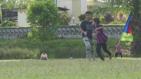 Children playing soccer on a simple field Stock Footage 220190123