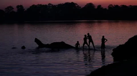 Children playing in the sunset Stock Footage 10443124