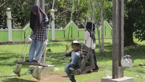 Children playing on the swing Stock Footage 220703588