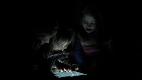 Children Playing on a Tablet at Night. Stock Footage 72622221