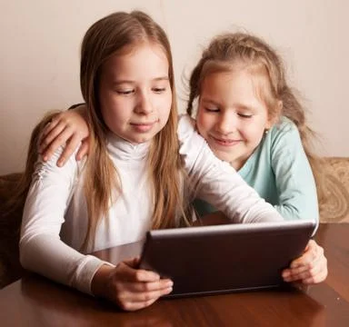 Children playing on tablet Stock Photos