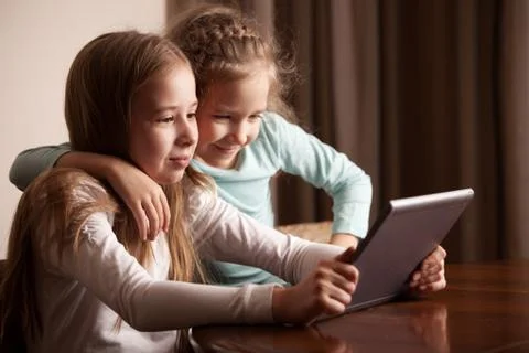 Children playing on tablet Stock Photos