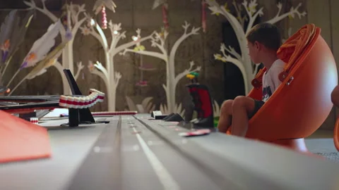 Children Playing with Tabletop Car Track in Playroom with Decorative Trees. Stock-Footage 338363009