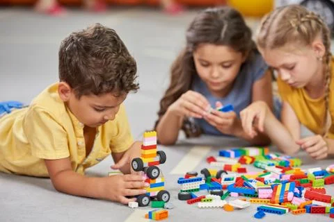 Children playing together in the classroom in kindergarten. Stock Photos