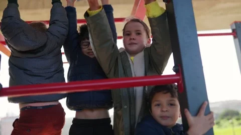 Children playing together on playground monkey bars Stock Footage 327760895