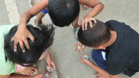 Children Playing Traditional Pogs Game On Philippine Neighborhood Streets Stock Footage 336636448