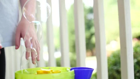 Children popping bubbles from a bubble machine close up on hands Stock Footage 207336328