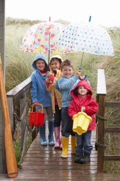 Children posing with umbrella Stock Photos