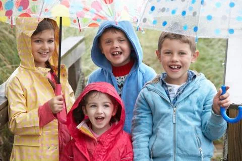 Children posing with umbrella Stock Photos