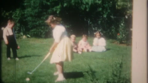 Children practice golf swings in backyard 1950s vintage film home movie 3412 Stock Footage 64723622