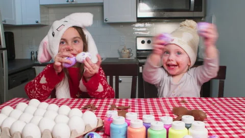 Children prepare for the Easter holiday at home in the kitchen. Stock Footage 233099945