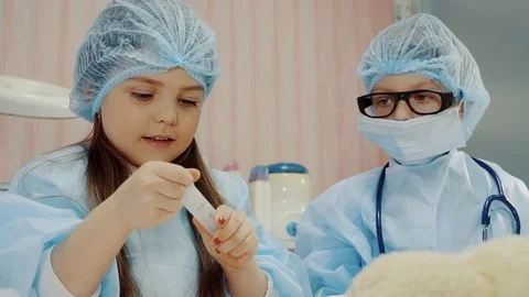 Children is preparing to do injections with toy syringe, want to be doctors Stock-Footage 86573966