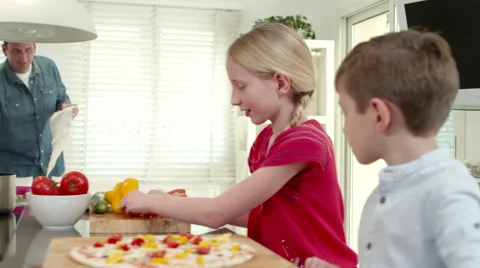 Children preparing pizza at kitchen. Stock Footage 64106761