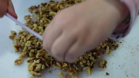 Children Preparing Walnuts on a Cutting Board Stock Footage 334975567