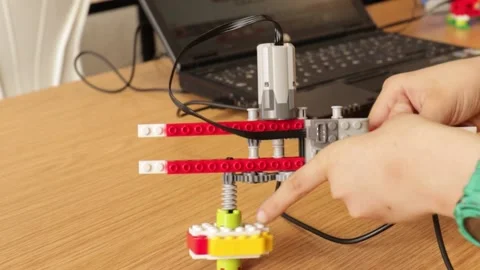 Children programming toys with computer Stock Footage 164324770