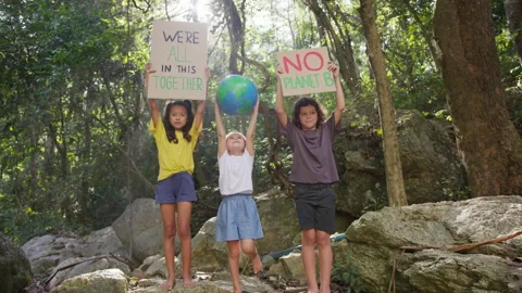 Children protesting and raising the posters and the globe above their heads Stock Footage 191452189
