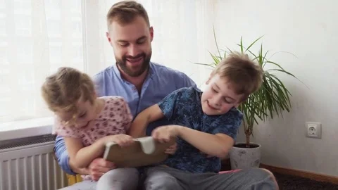Children pull the tablet out of each other's hands Stock Footage 82441187