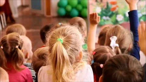 Children raising their hands to answer a question Stock Footage 77861055