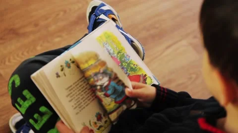 Children read and leaf through a book of Russian fairy tales Stock Footage 53748016