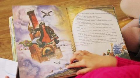 Children read and leaf through a book of Russian fairy tales 库存影片 53748246
